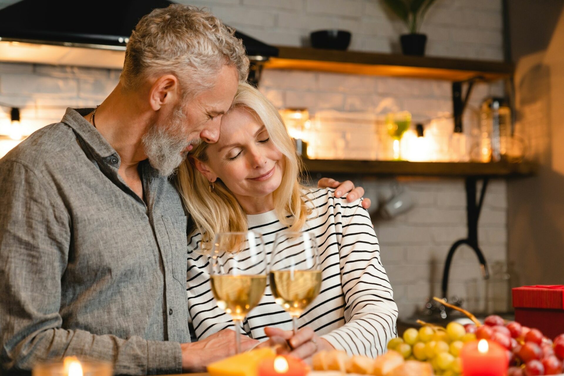 Passionate mature caucasian couple during romantic date in the kitchen